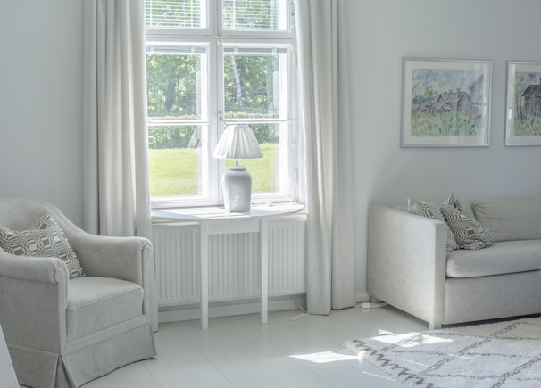 A freshly painted cozy living room with soft cream walls and bright white trim.