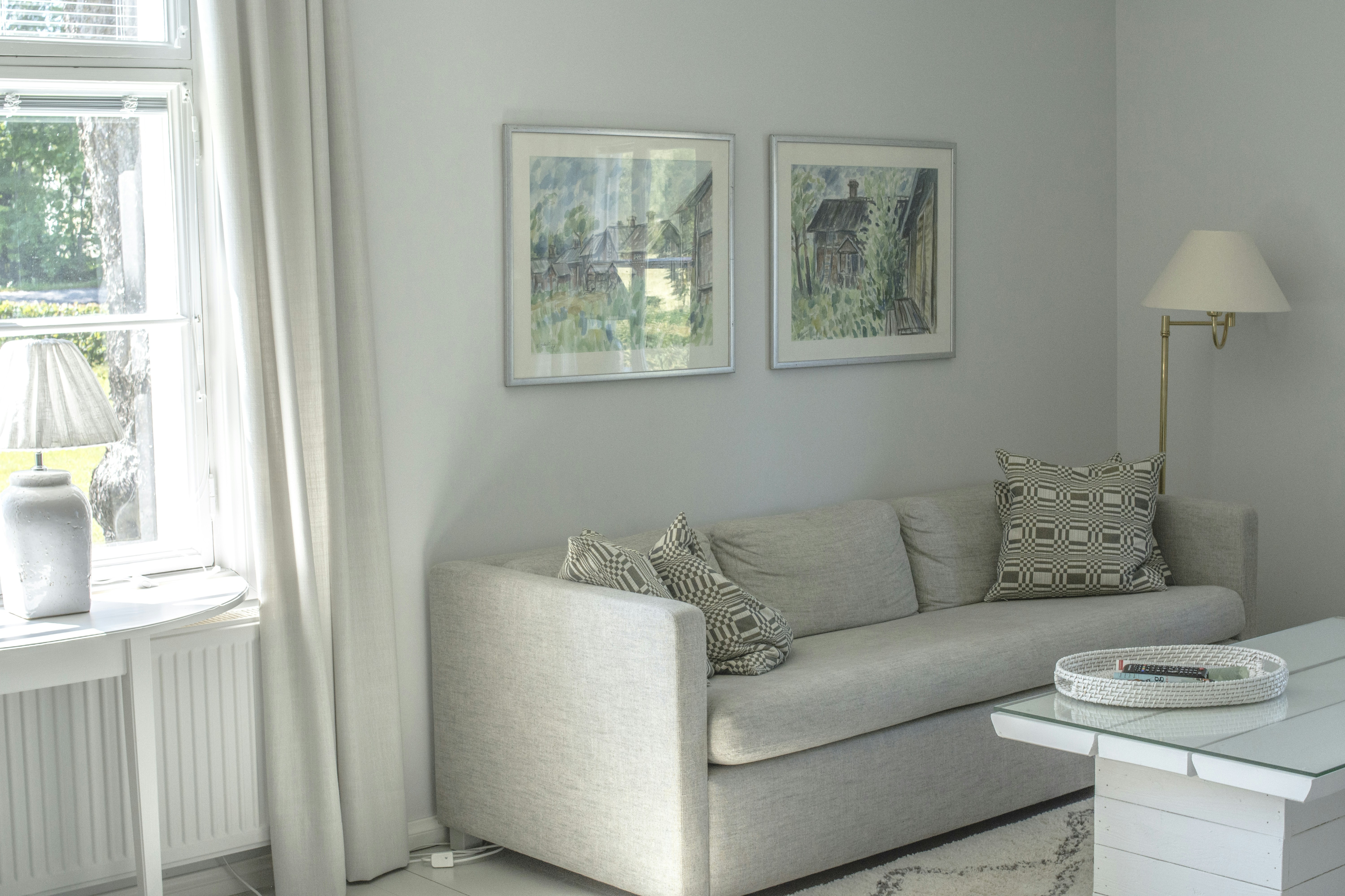 gray and white throw pillows on gray couch