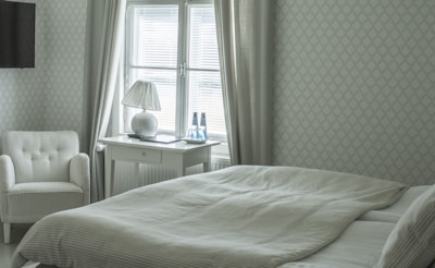 A serene bedroom with elegant decor and natural light.