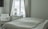 A serene bedroom scene with a calming atmosphere, featuring a bottle of supplements on a bedside table.