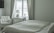 A serene bedroom scene with a calming atmosphere, featuring a bottle of supplements on a bedside table.