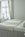 white bed linen near white wooden nightstand