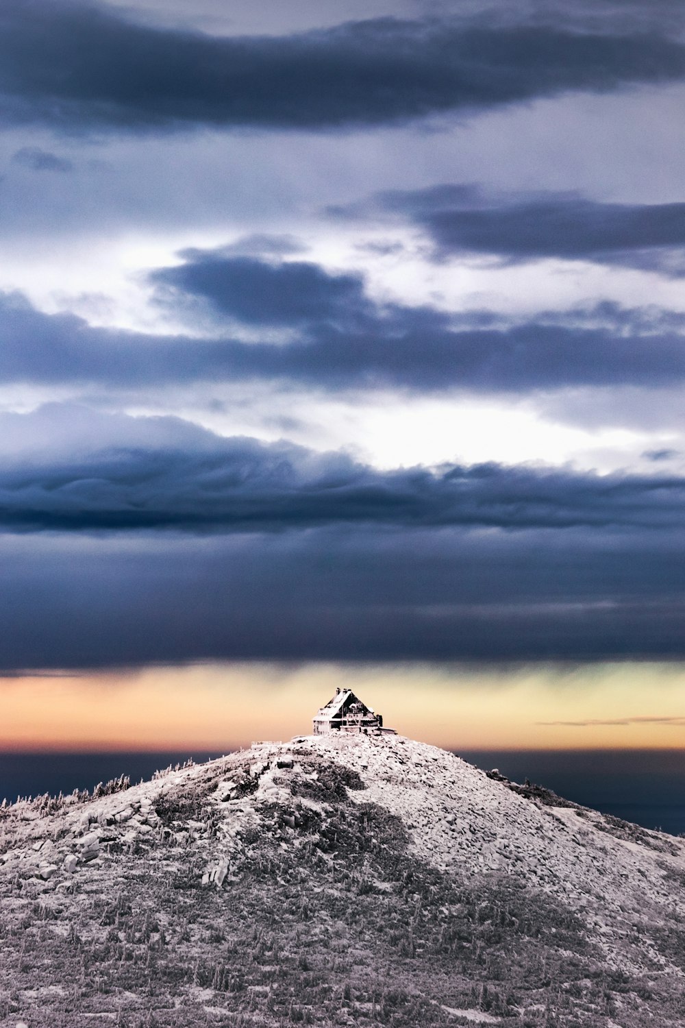 gray mountain under cloudy sky during daytime