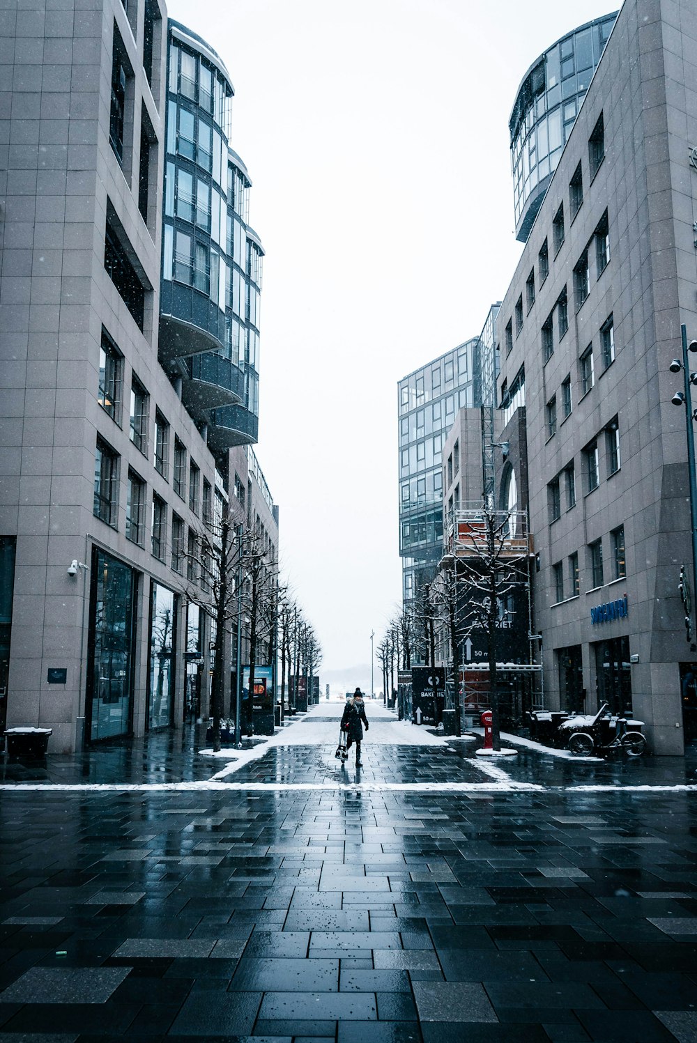 person in black coat walking on street during daytime