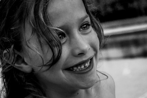 grayscale photo of smiling girl