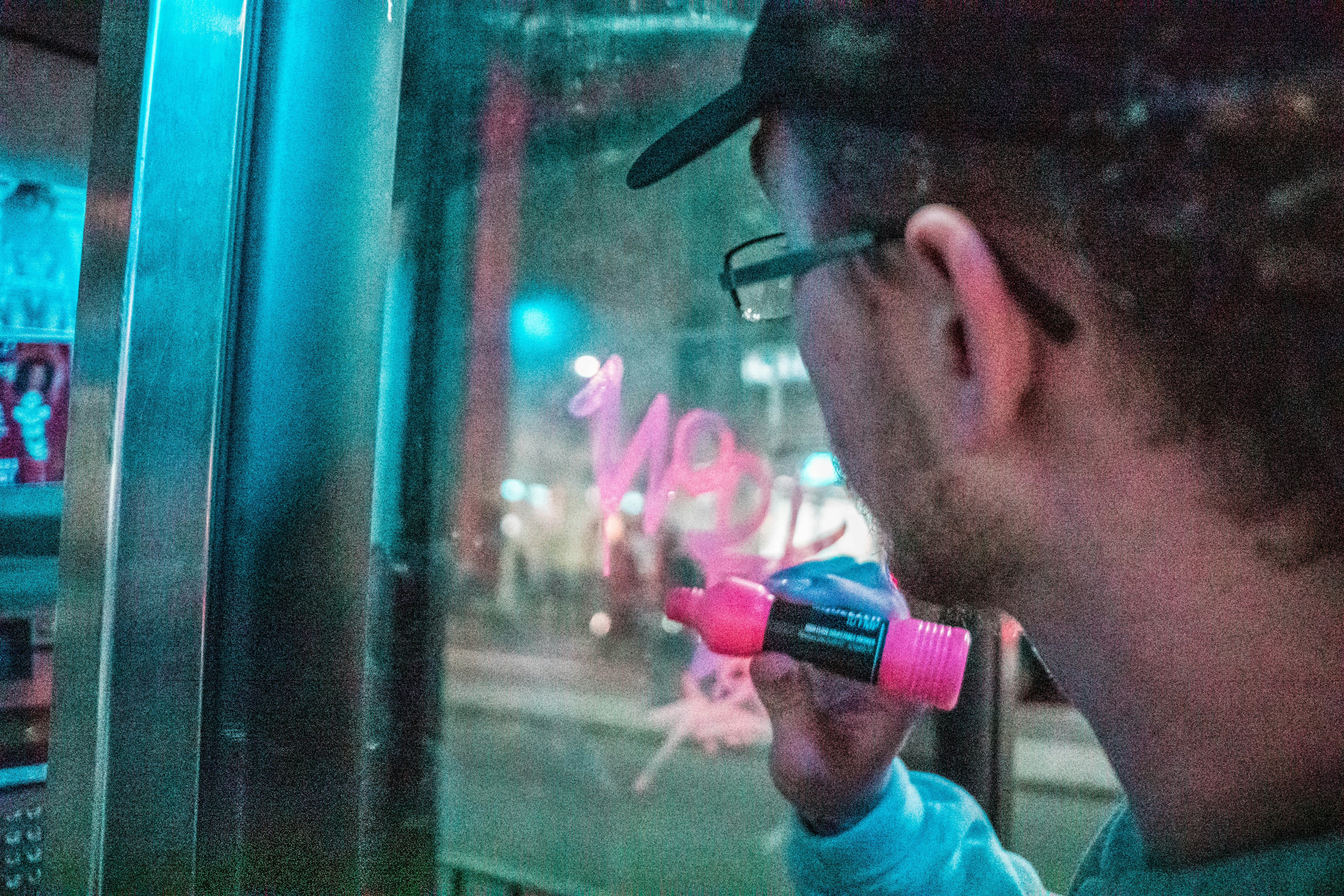 man in white crew neck shirt smoking cigarette