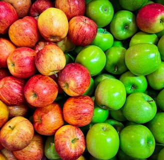 green and red apples on white plastic container