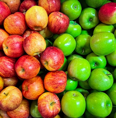 green and red apples on white plastic container