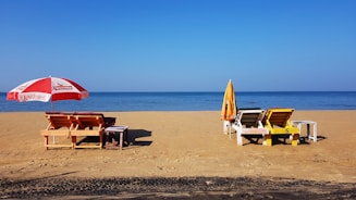 brown wooden chairs on beach during daytime
