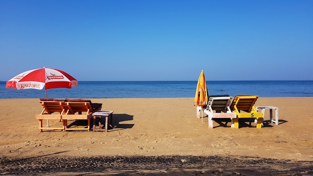 brown wooden chairs on beach during daytime