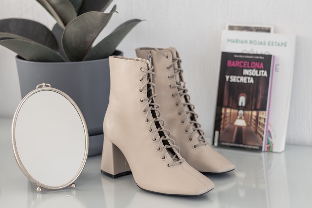 brown leather boots on white table