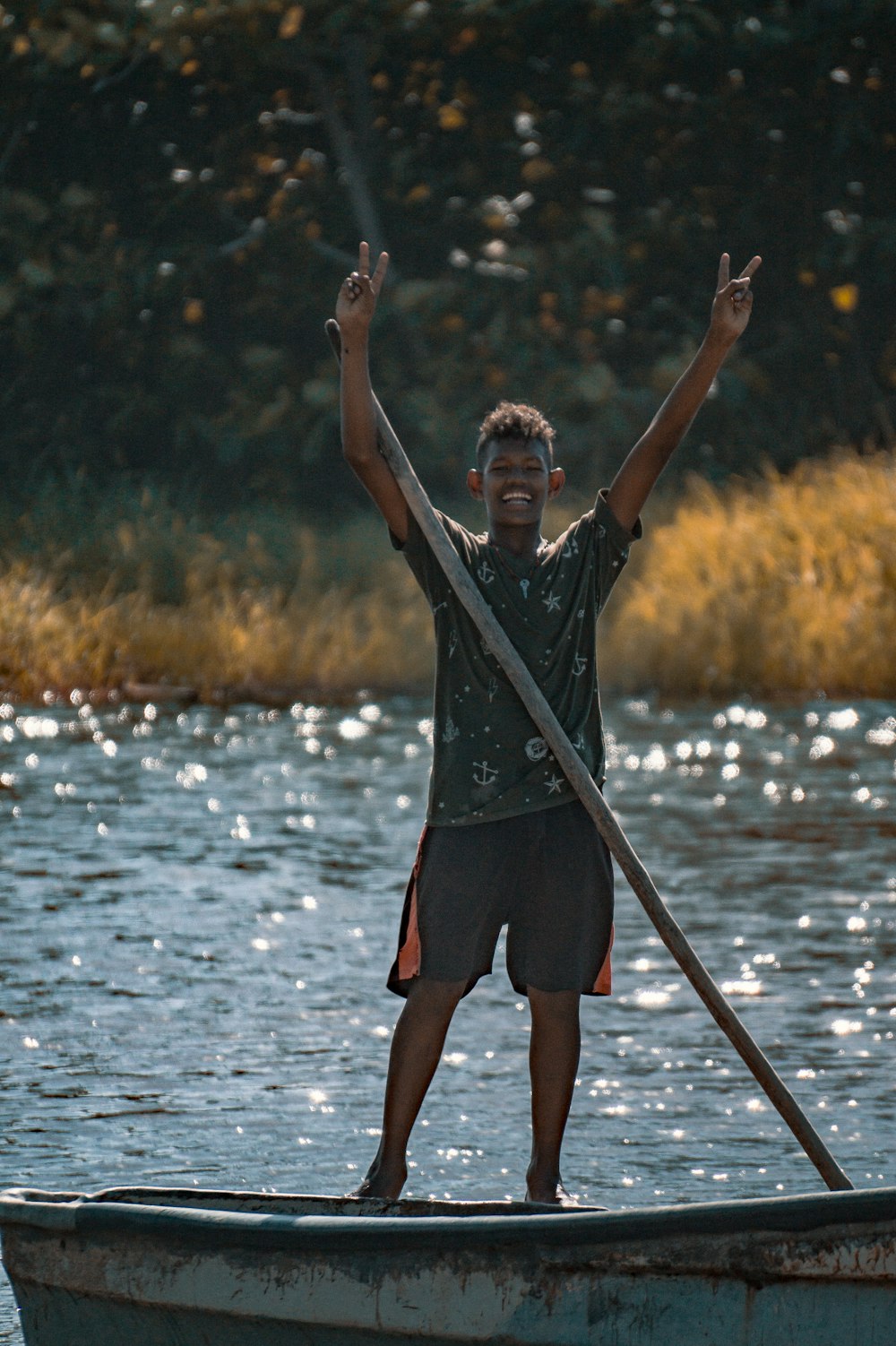 man in black t-shirt and red shorts standing on water during daytime