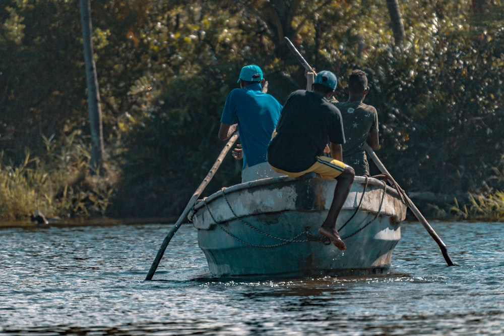 2 men riding on boat on river during daytime