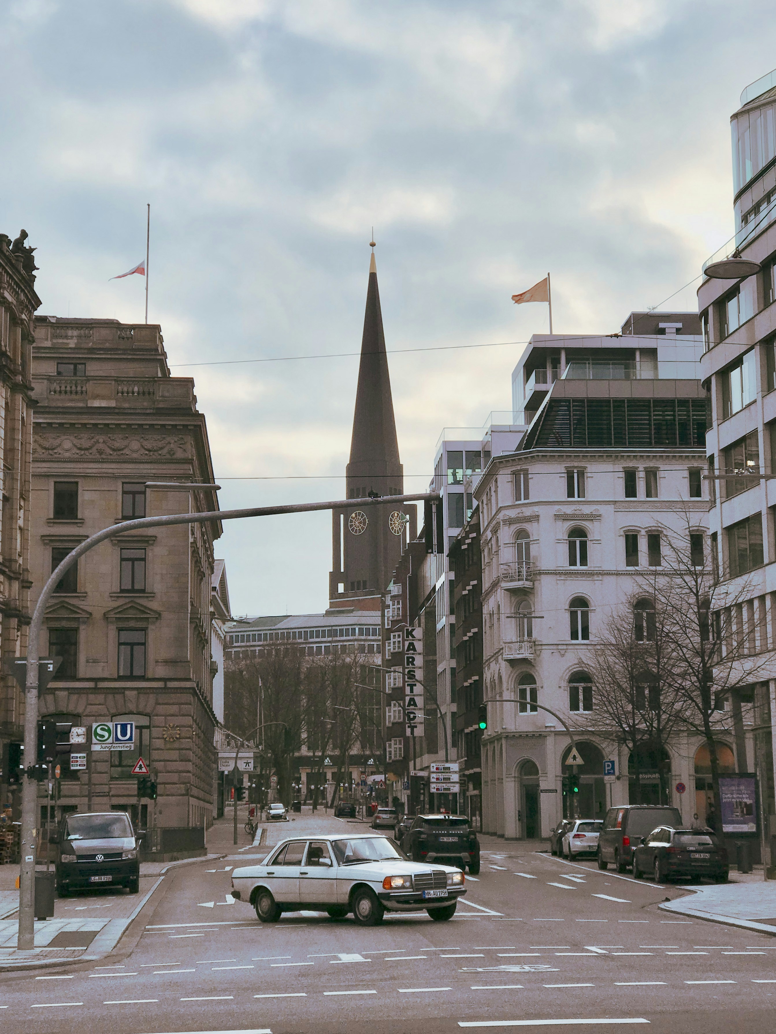 Cars parked on side of the road near high rise buildings during daytime ...