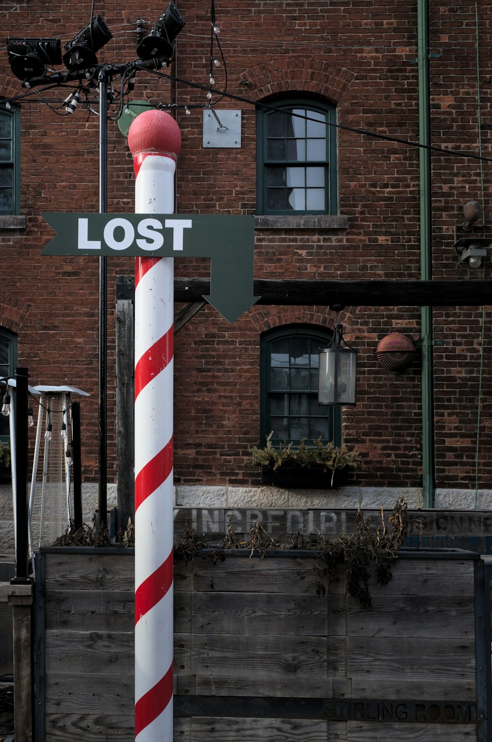 red and white striped post near brown concrete building