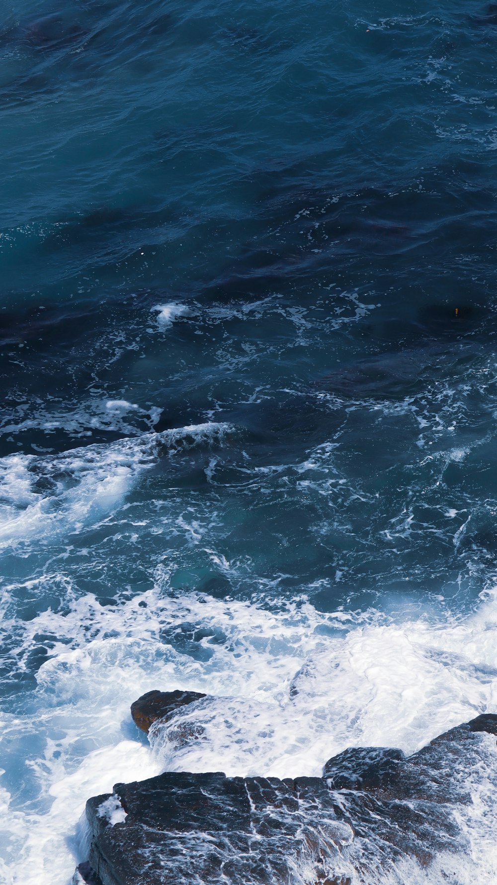 water waves on blue ocean water during daytime