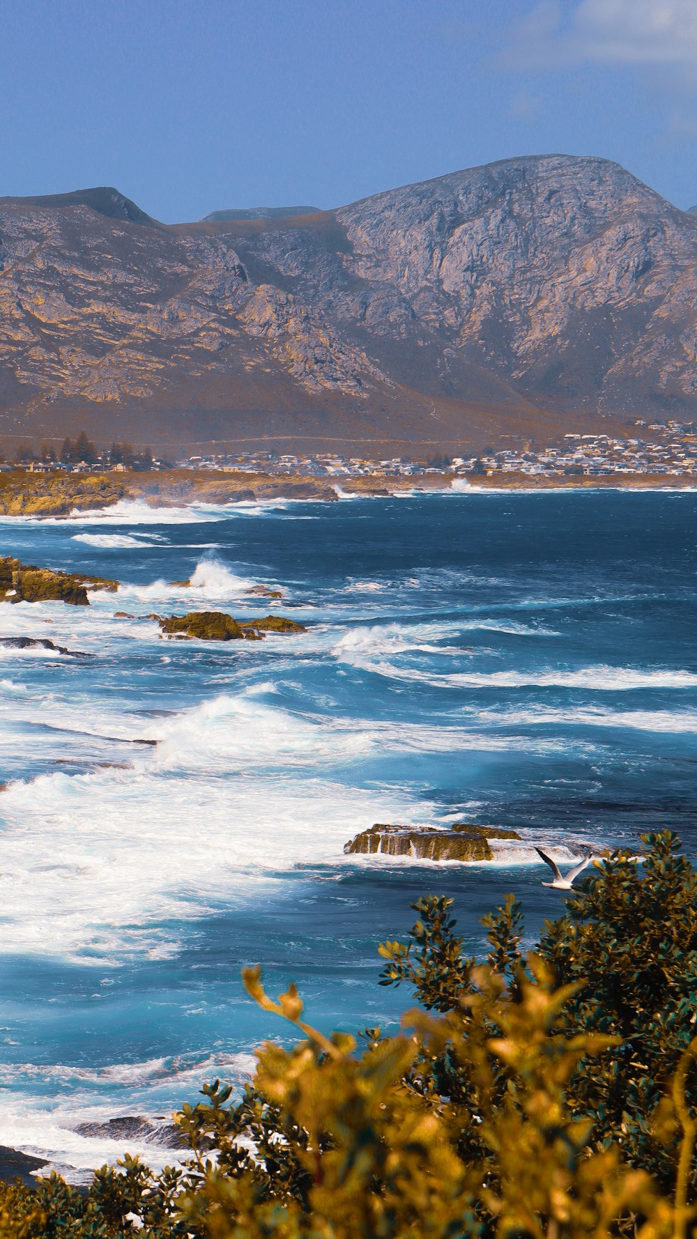 aerial view of body of water near mountain during daytime