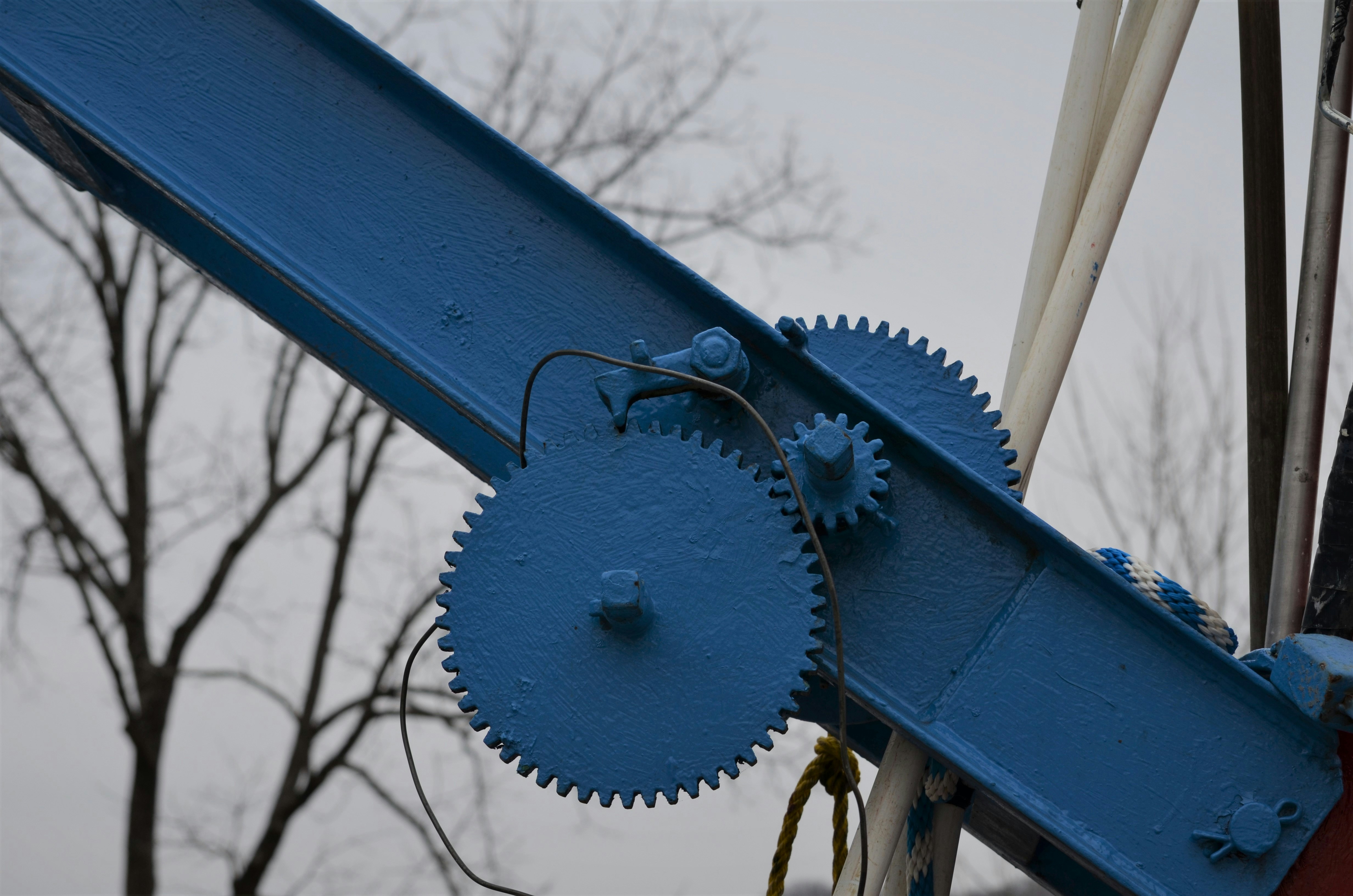 blue metal fence with brown wooden wheel