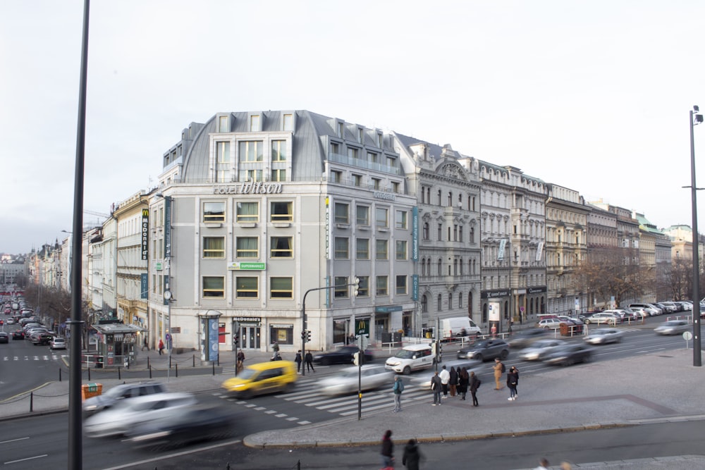 cars parked in front of white building during daytime