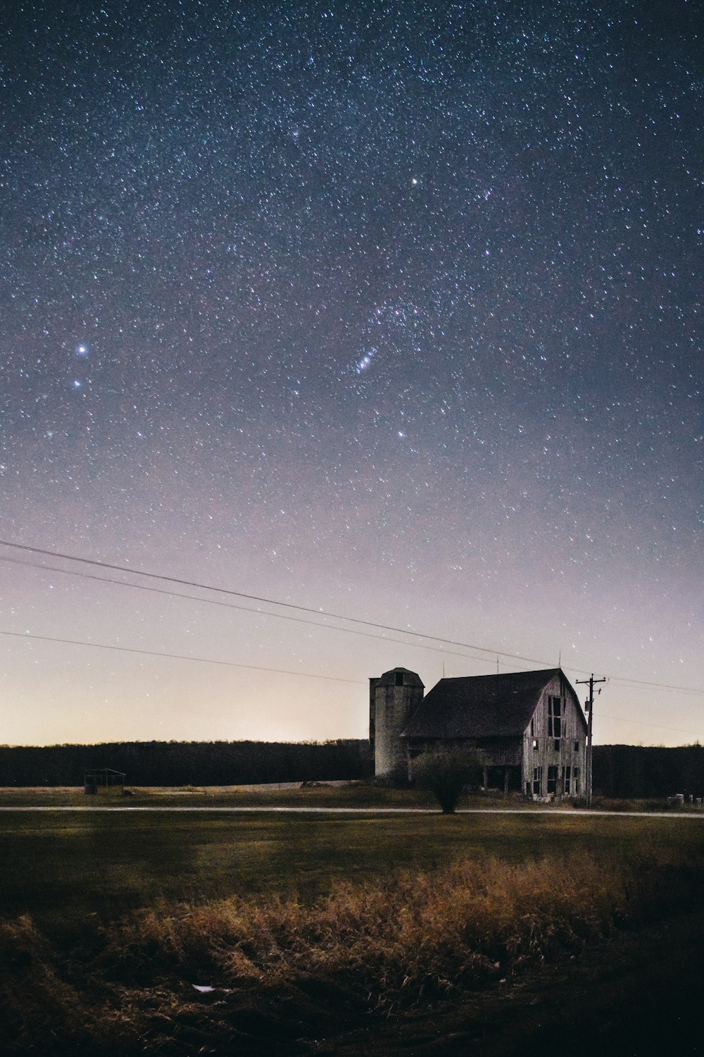 gray concrete building near body of water under starry night