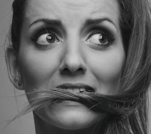 grayscale photo of woman with silver nose ring