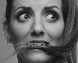 grayscale photo of woman with silver nose ring