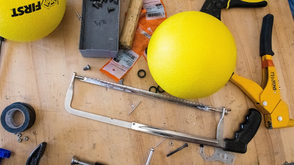yellow ball beside gray metal tool