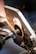 A metal grinding process where sparks are flying as a circular grinding tool is working on a piece of metal. The scene appears to be in a workshop setting with detailed focus on the machine and the metal piece.