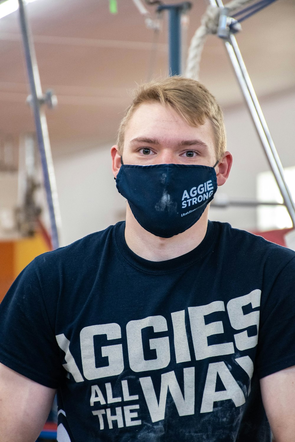 boy in blue crew neck shirt wearing blue and white mask