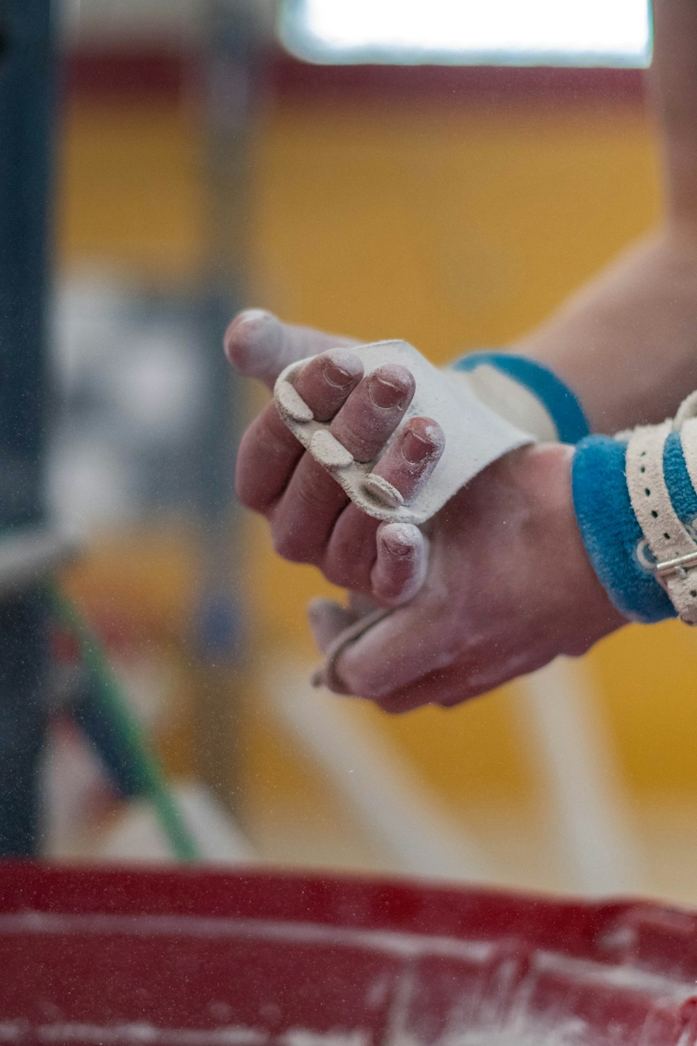 person wearing white and blue silicone bands