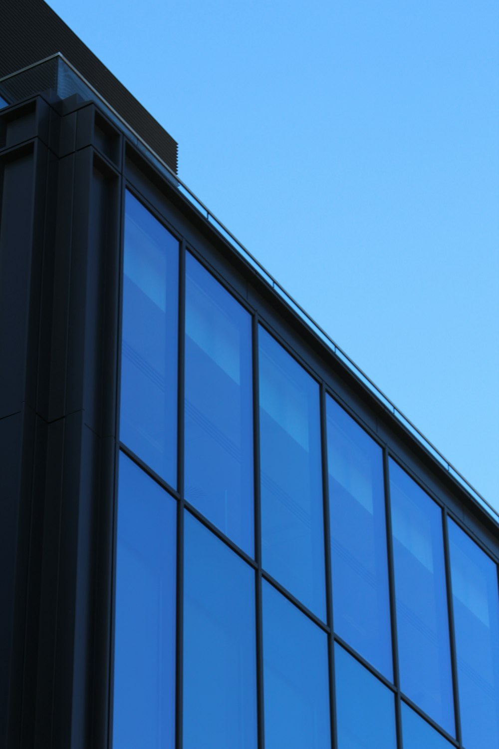 black glass window building under blue sky during daytime