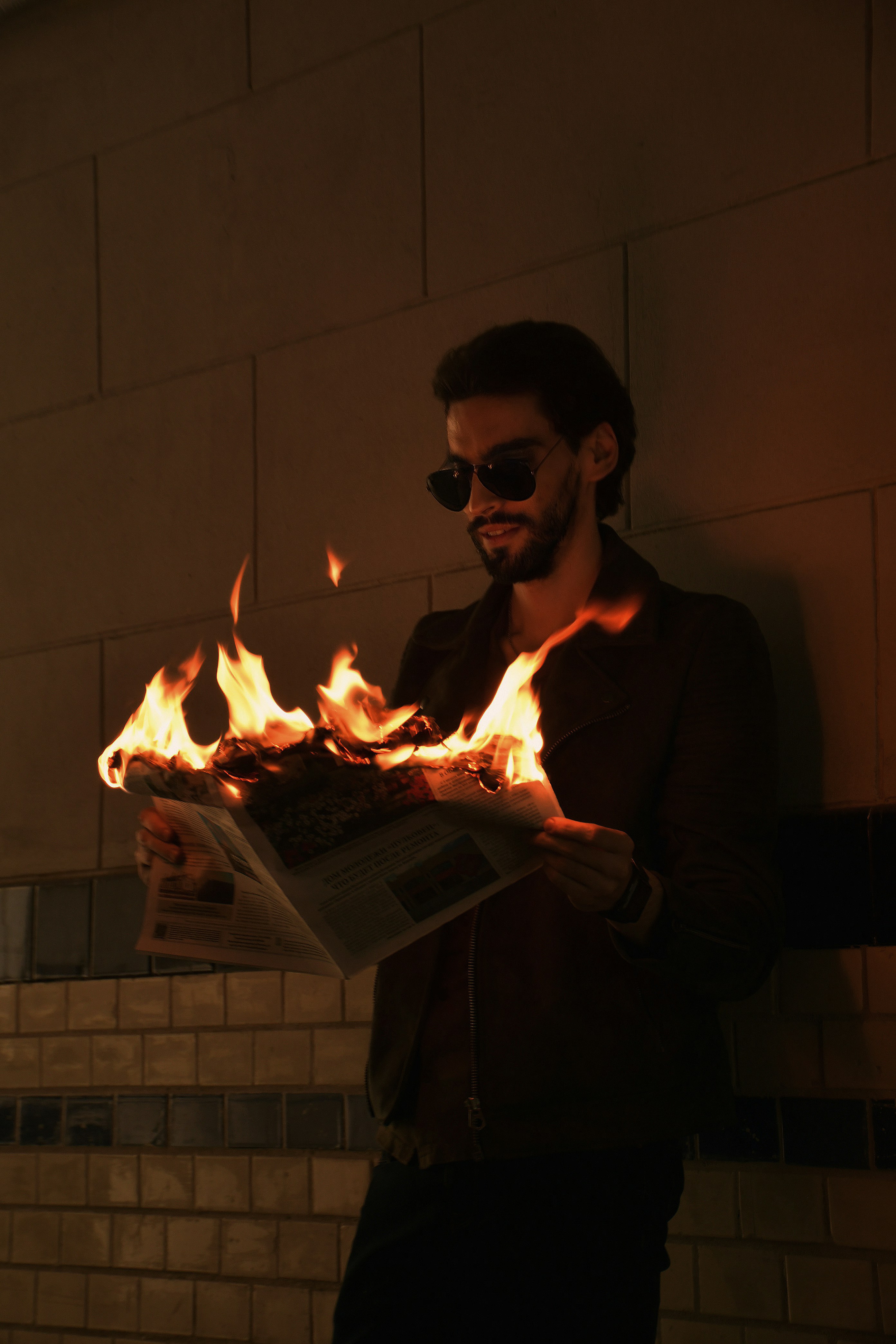 woman in black long sleeve shirt holding burning paper