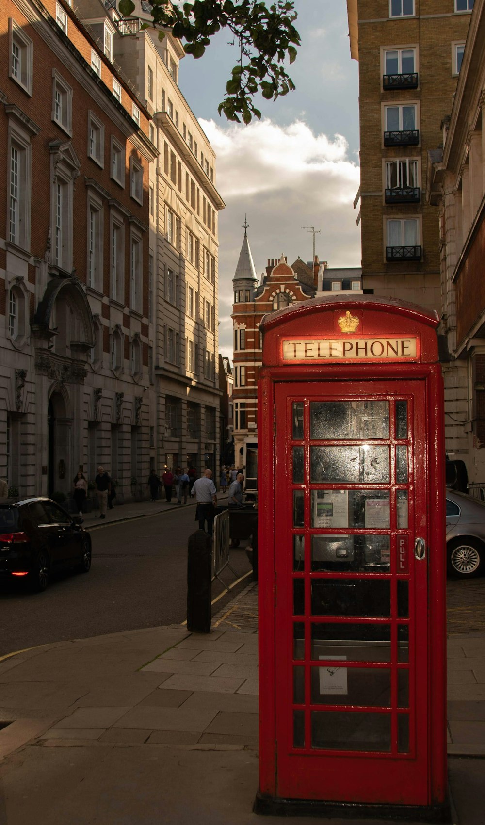 red telephone booth in the middle of the street