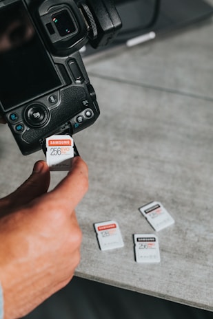 Close-up of a sleek Vigishop memory card next to a laptop.