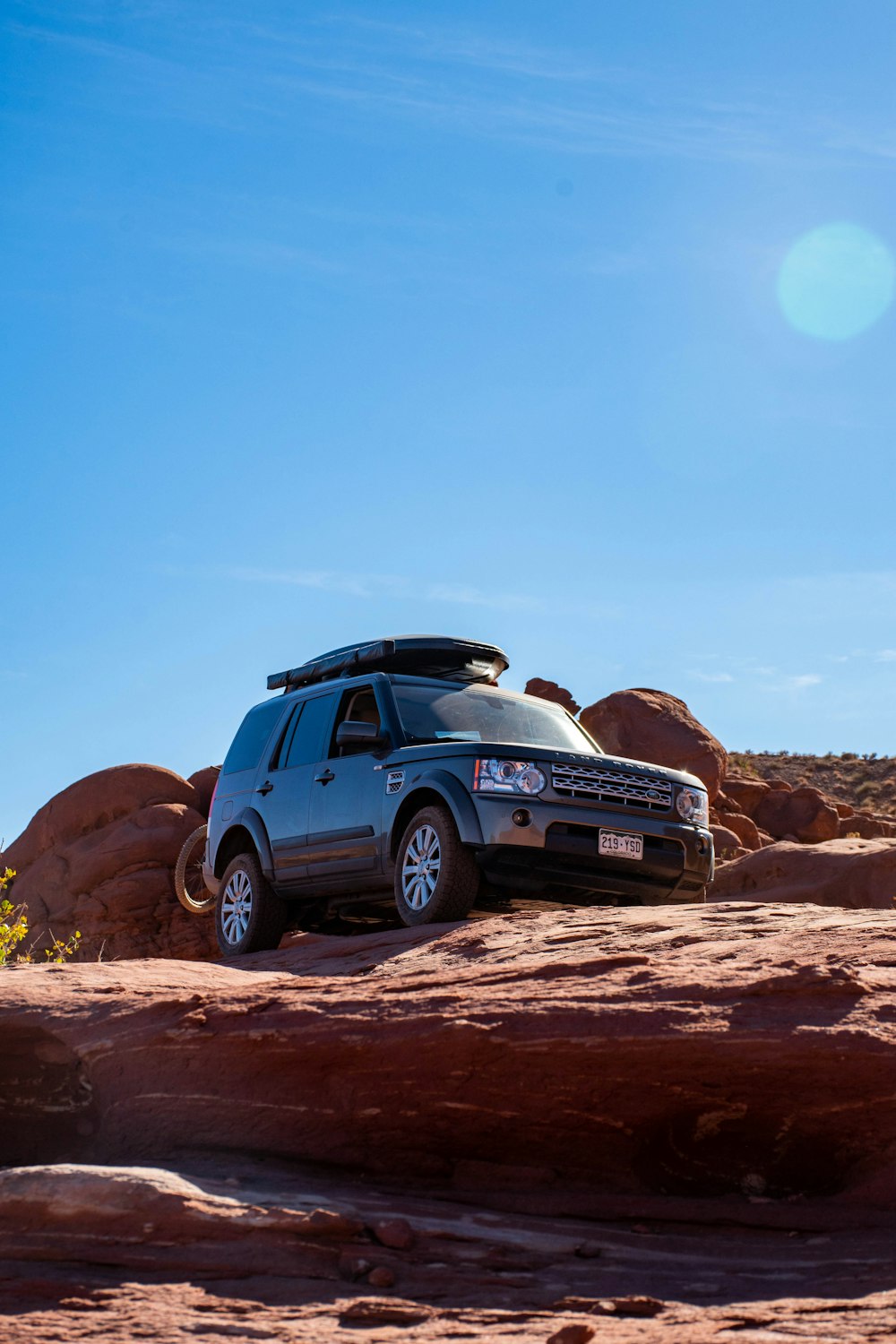 black suv on brown rock formation during daytime