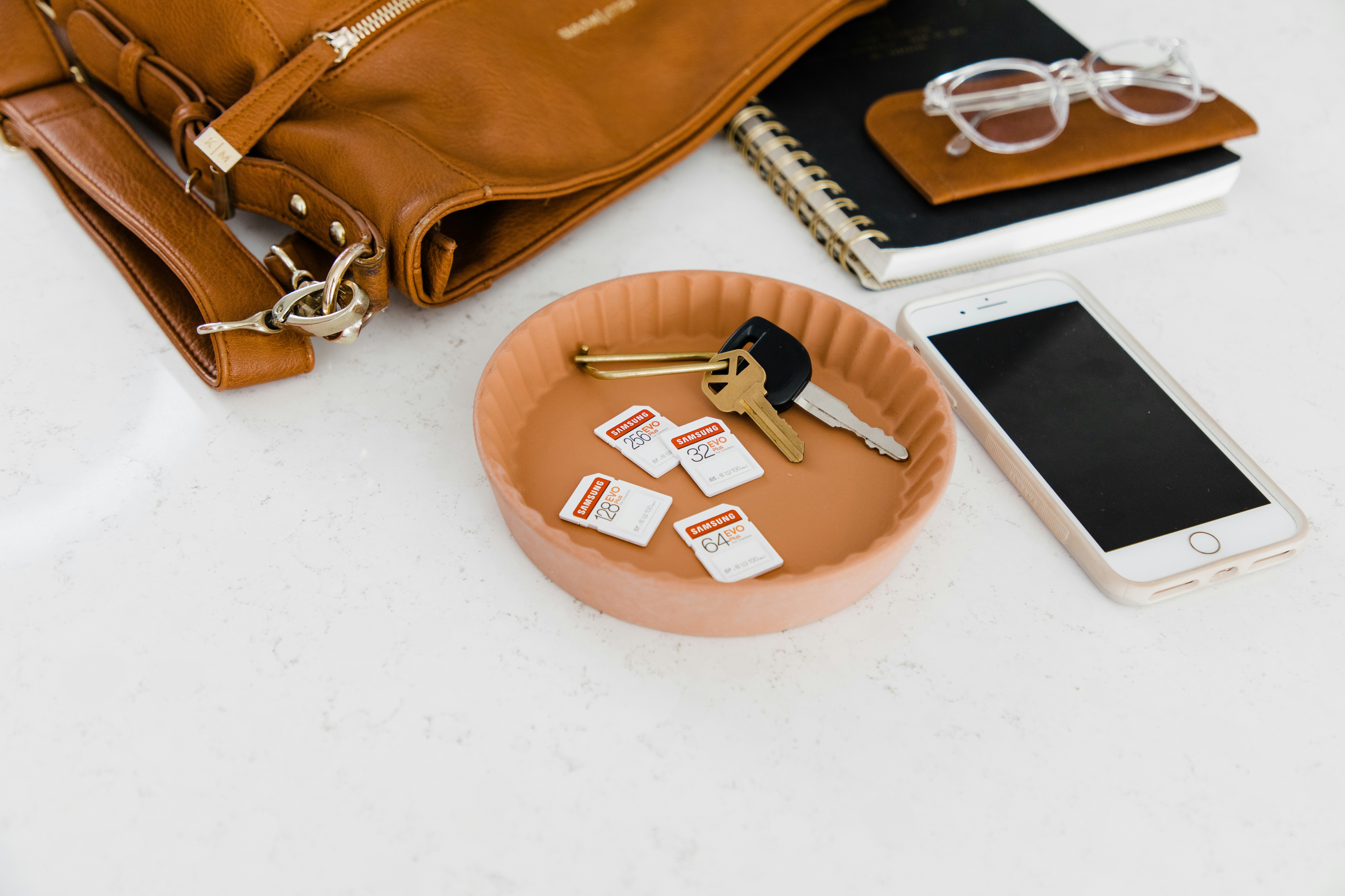 brown leather bag on white table
