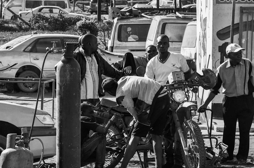 grayscale photo of man and woman riding motorcycle