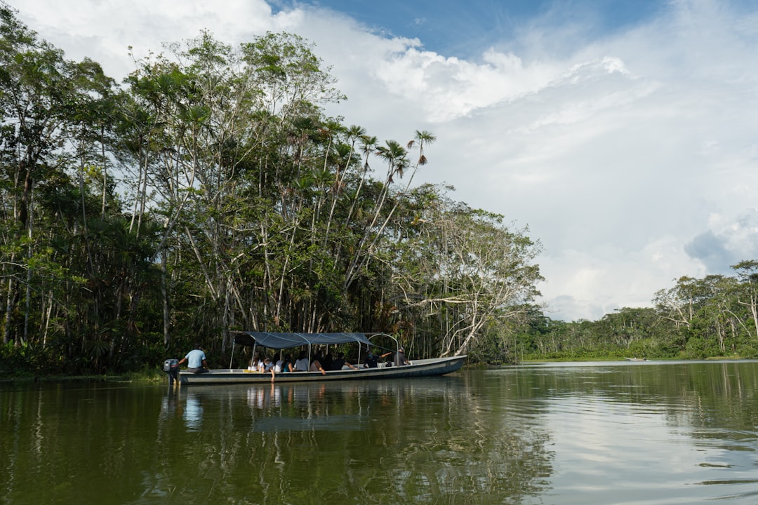 people riding boat on river during daytime