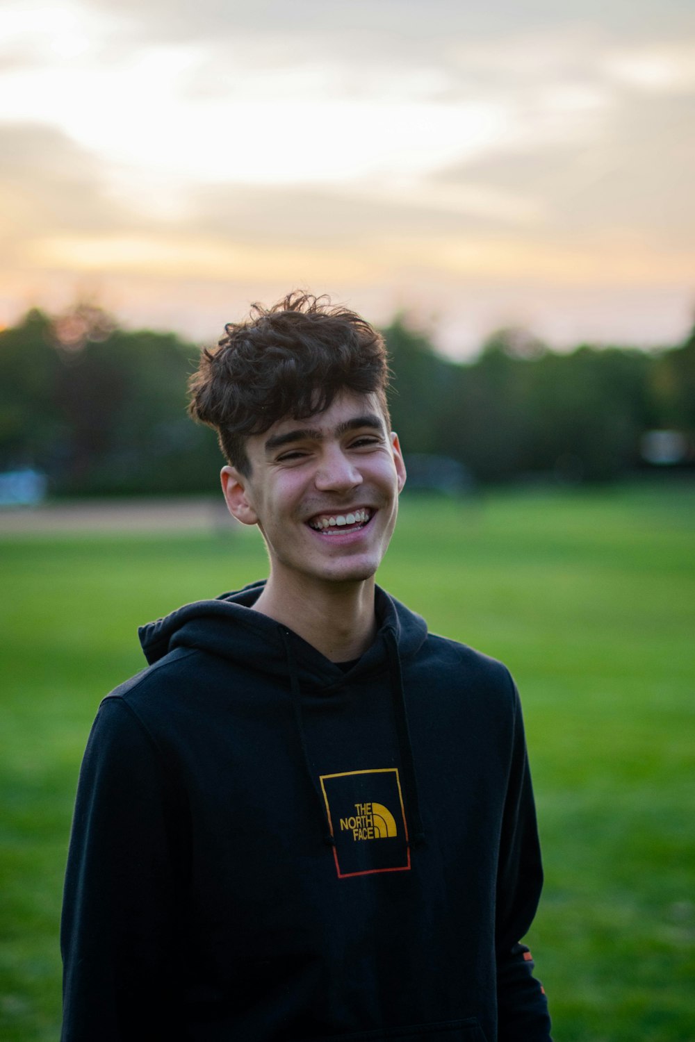 smiling man in blue hoodie