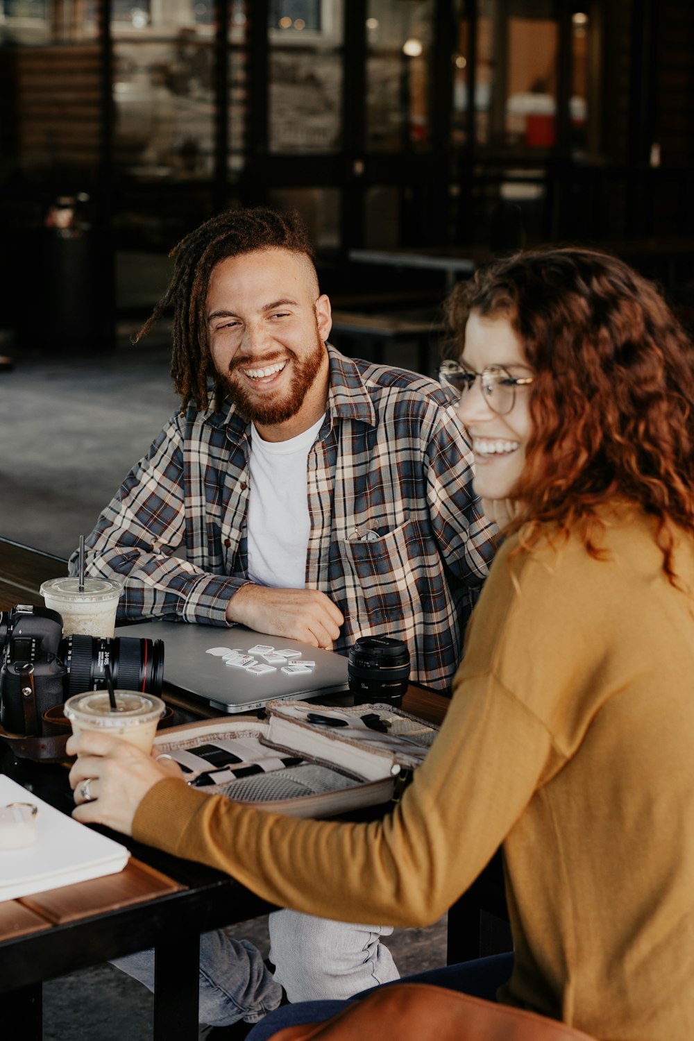 man and woman sitting on chair smiling