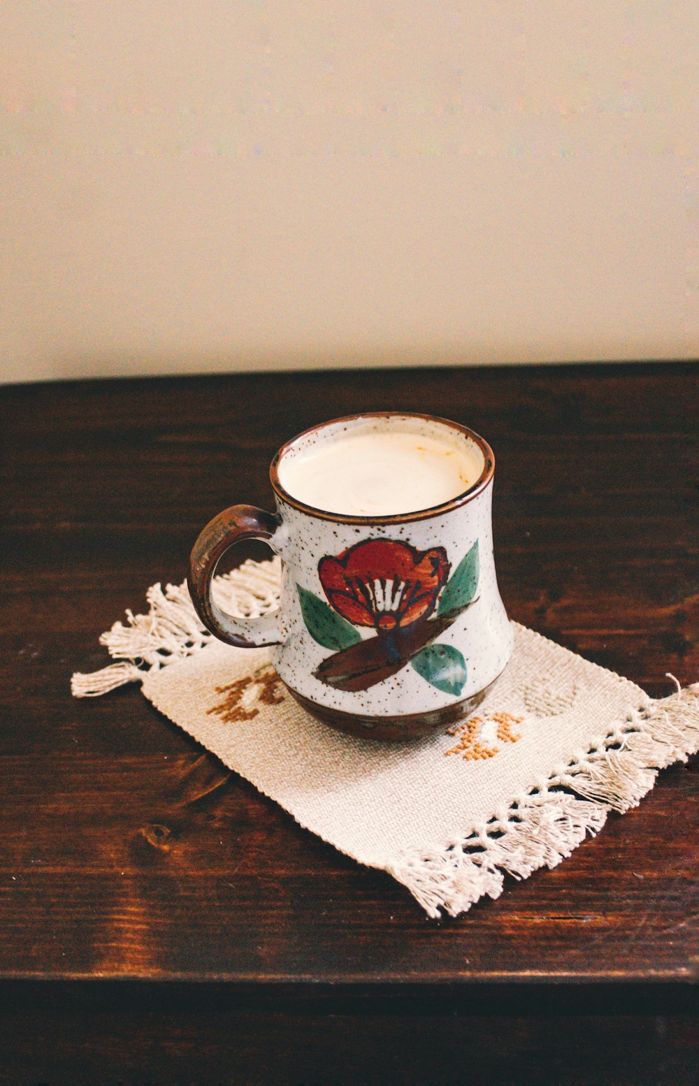 white and blue floral ceramic mug on white and blue floral table cloth