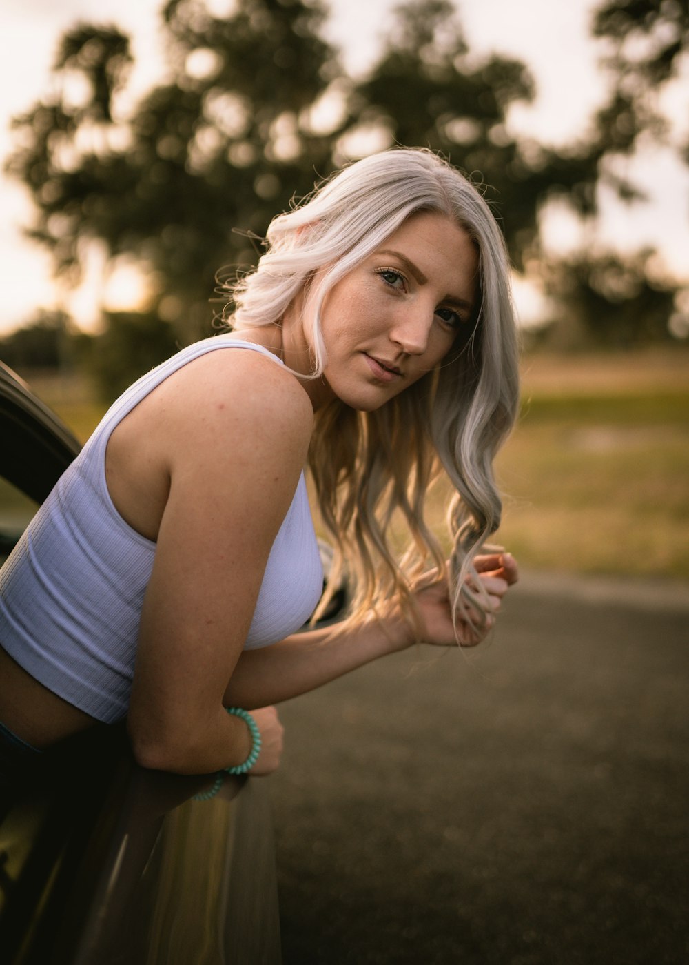 woman in white tank top smiling