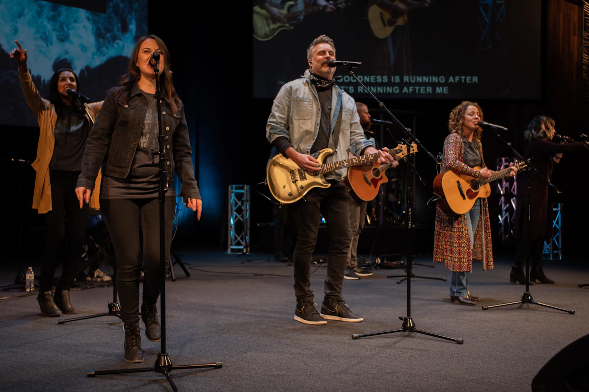 A worship band playing guitars on stage