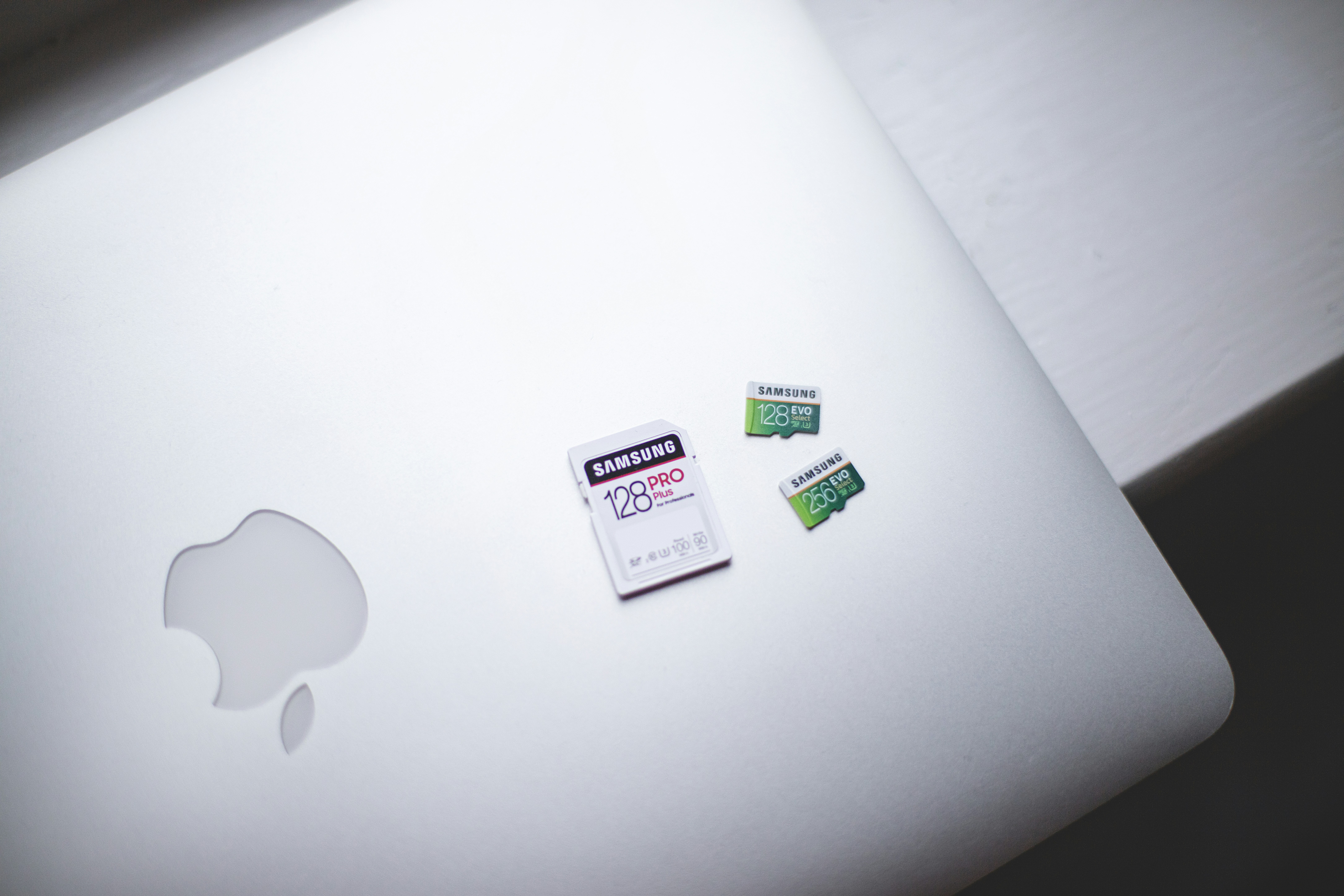 white macbook on brown wooden table