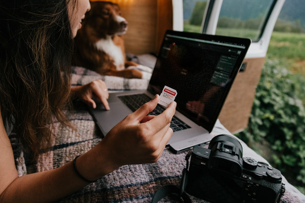 woman holding iphone sitting on chair