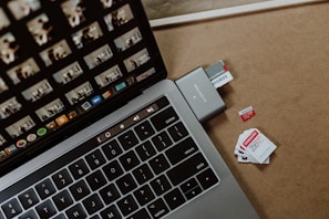 Compact data storage device next to a modern keyboard.