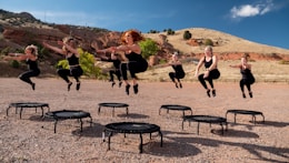 people sitting on black metal chairs on brown rocky mountain during daytime