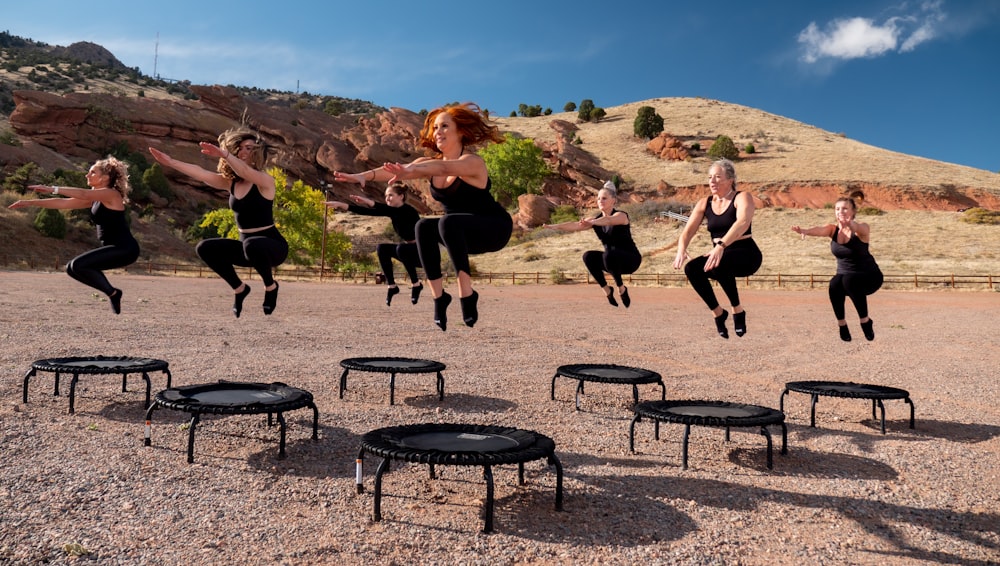 people sitting on black metal chairs on brown rocky mountain during daytime