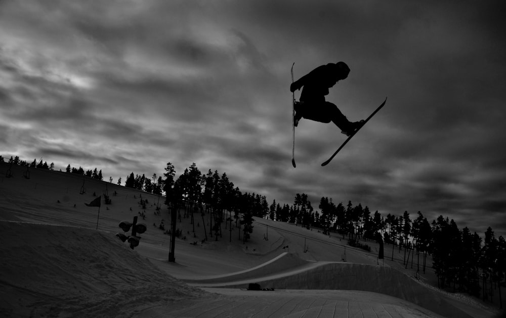 grayscale photo of people riding ski lift