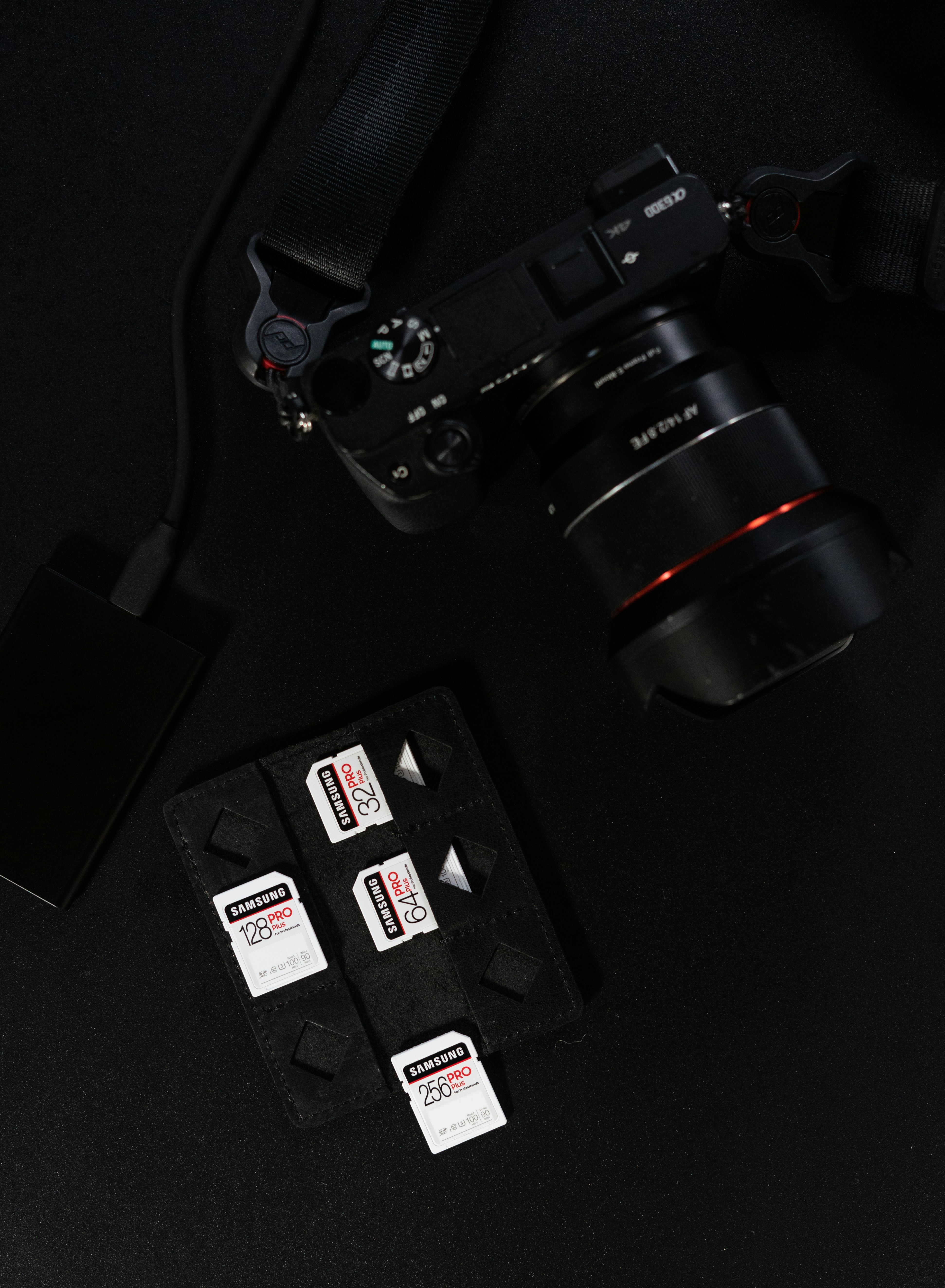 black nikon dslr camera on black surface